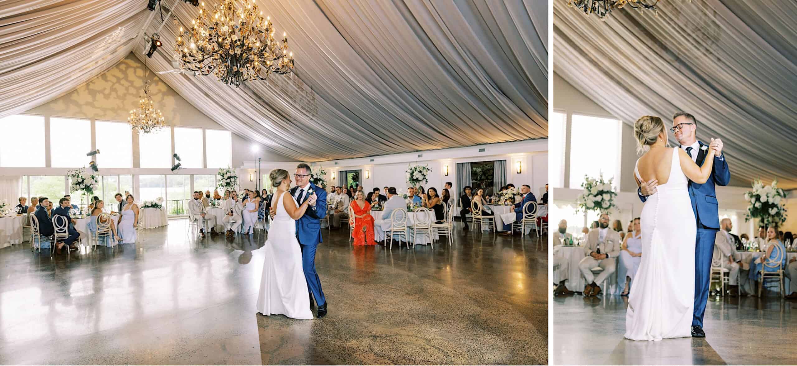 A bride and groom share their first dance in a bright, elegant Lake House Inn Wedding reception hall with chandeliers, draped ceiling, and seated guests watching.