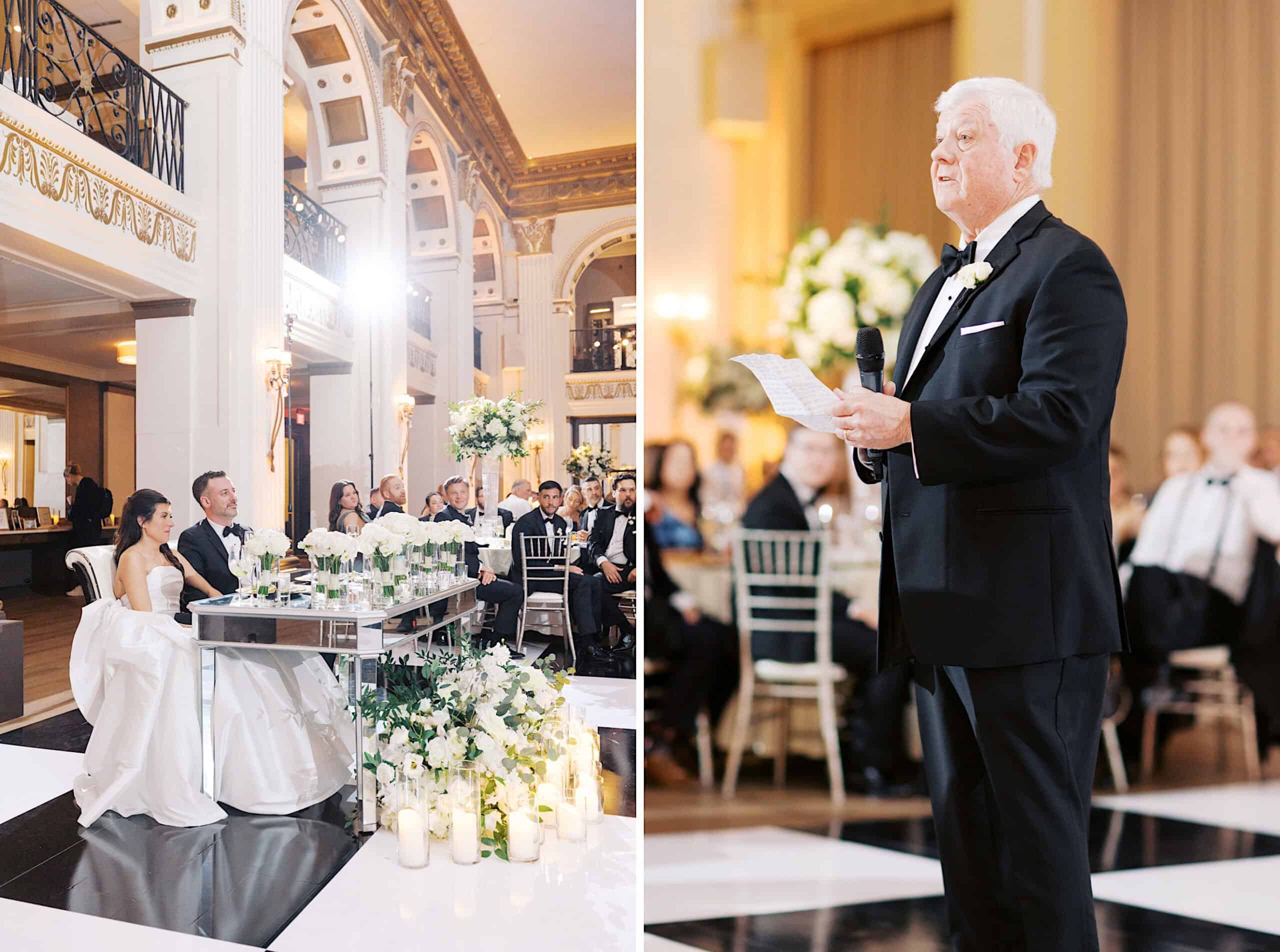 A bride and groom sit at a decorated table during a formal Classic Wedding at Ballroom at the Ben while an older man in a tuxedo gives a speech to seated guests.