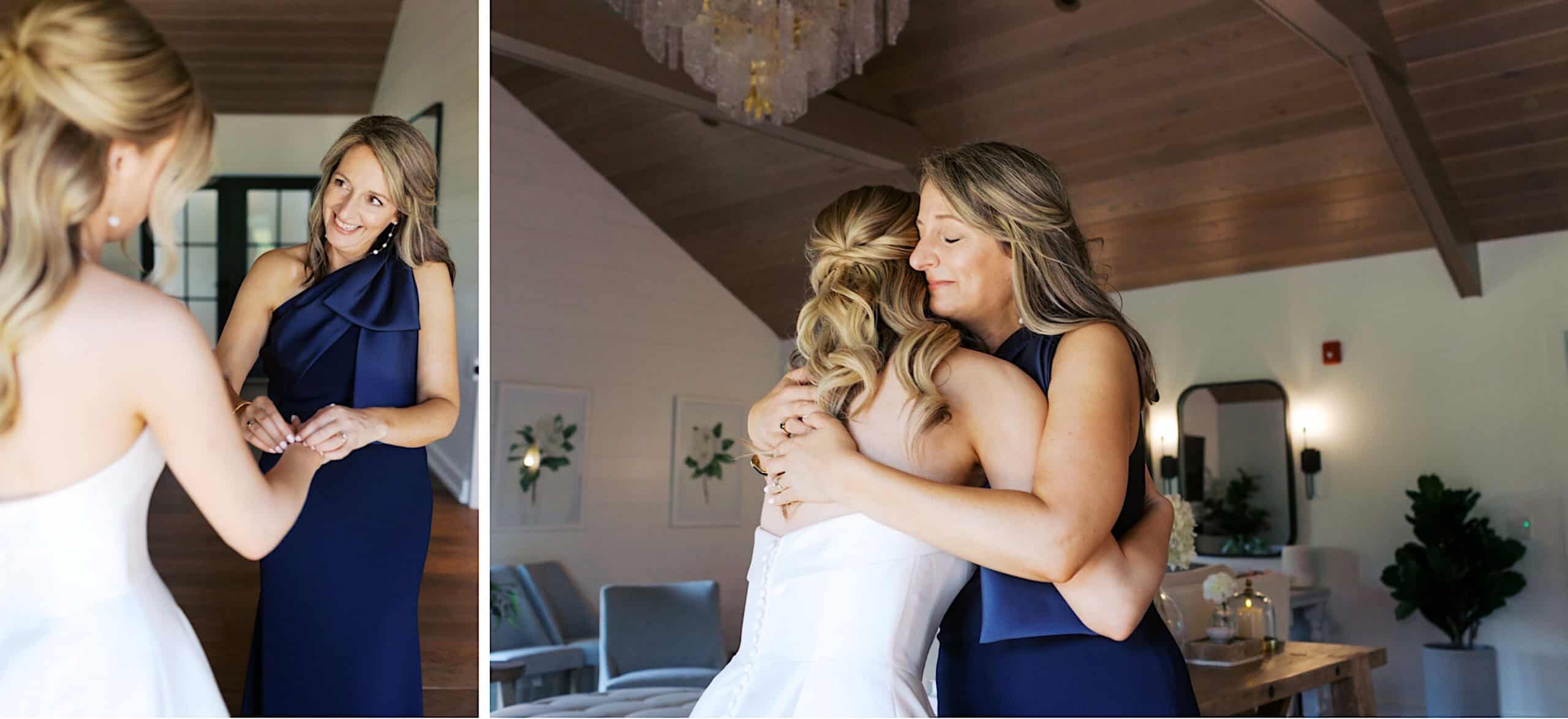 Two women in formal attire, one in a white dress and the other in navy, share a heartfelt moment holding hands and embracing during their Westwynd Gardens Spring Wedding in a bright, elegantly decorated room.