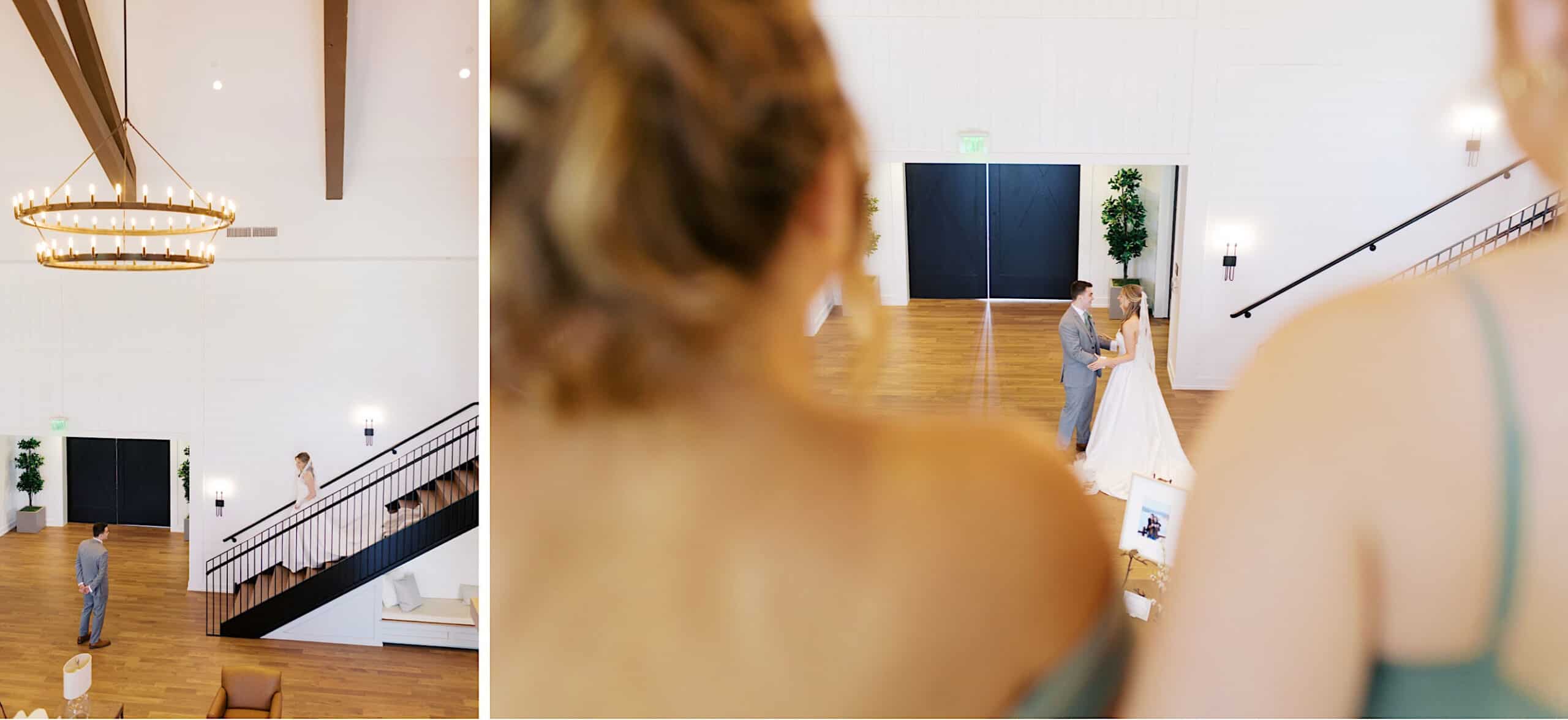 A bride and groom stand together in a spacious, modern hall at a Westwynd Gardens Spring Wedding while a person in the foreground observes them from the balcony.