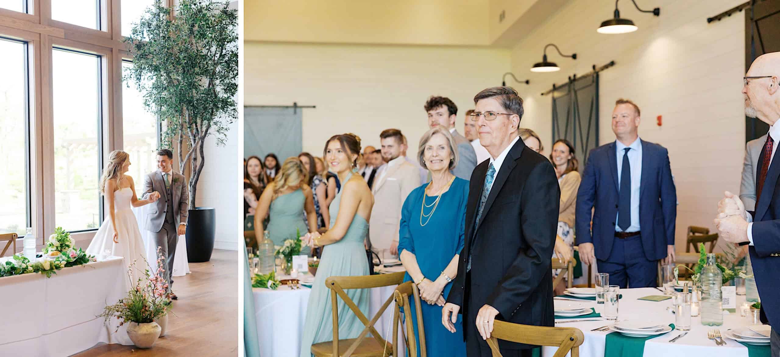 At a Westwynd Gardens Spring Wedding, a bride and groom stand by a window as guests inside the venue rise from their seats, looking in their direction. Tables are beautifully set with blue and white decor.