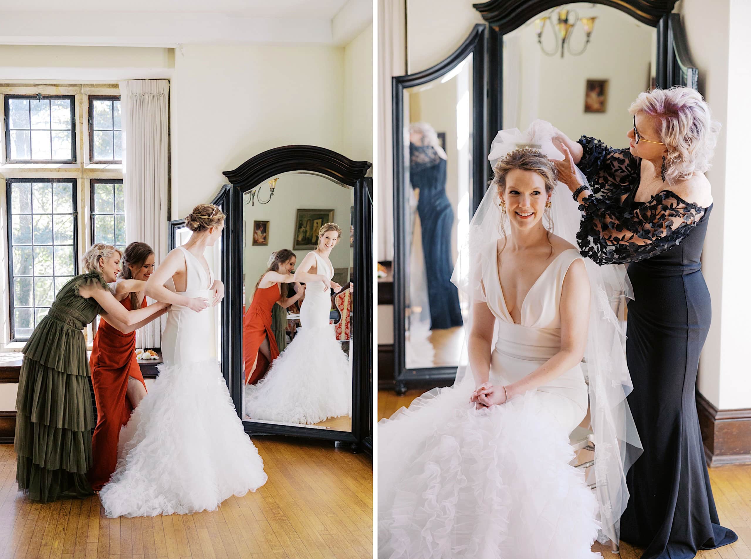 Two women help a bride adjust her wedding dress; another woman arranges the bride’s veil as she sits smiling in front of a large mirror in a bright room with wooden floors, preparing for her Parque Ridley Creek garden ceremony.